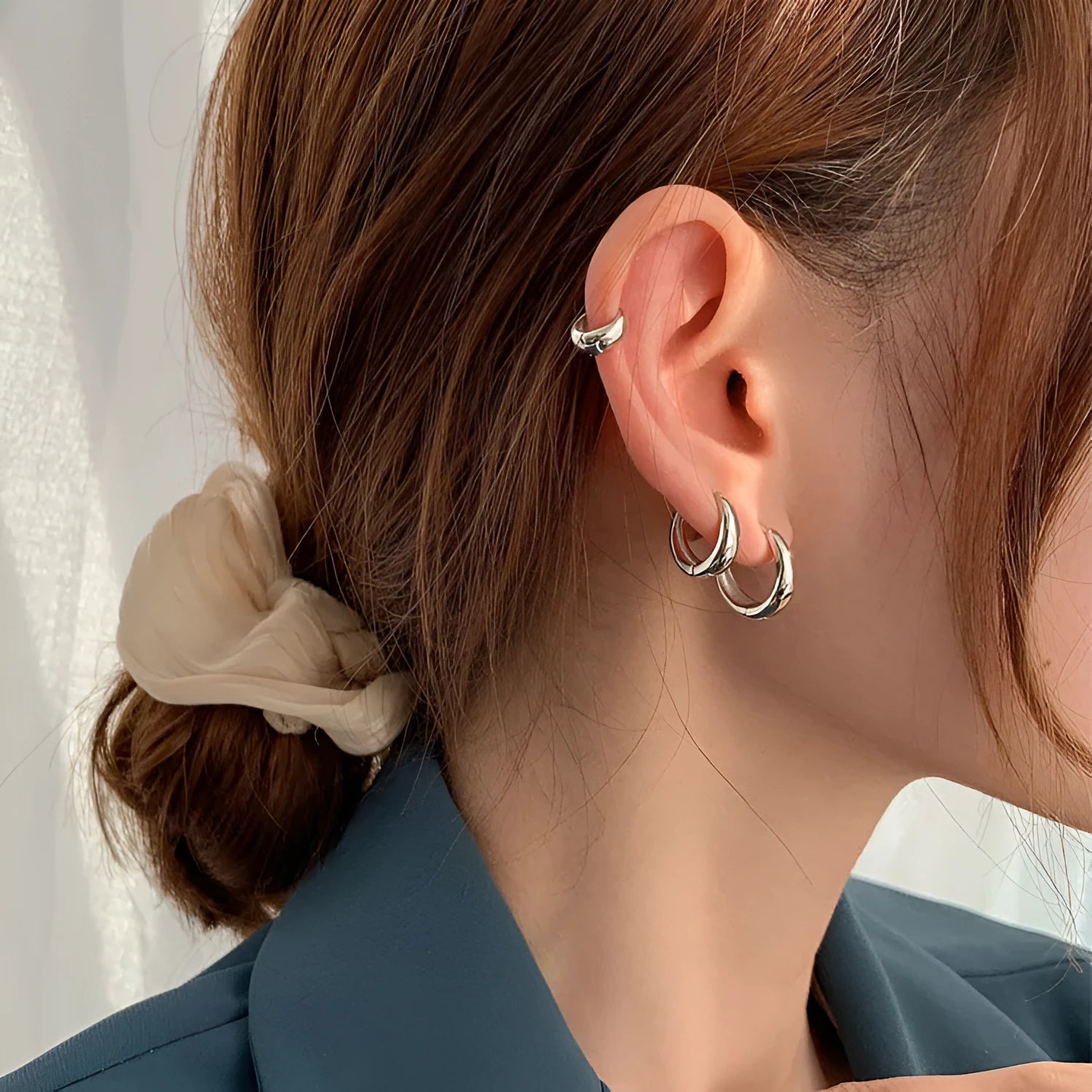 Women's minimalist copper water drop earrings in gold or silver, shown in large, medium, and small sizes.