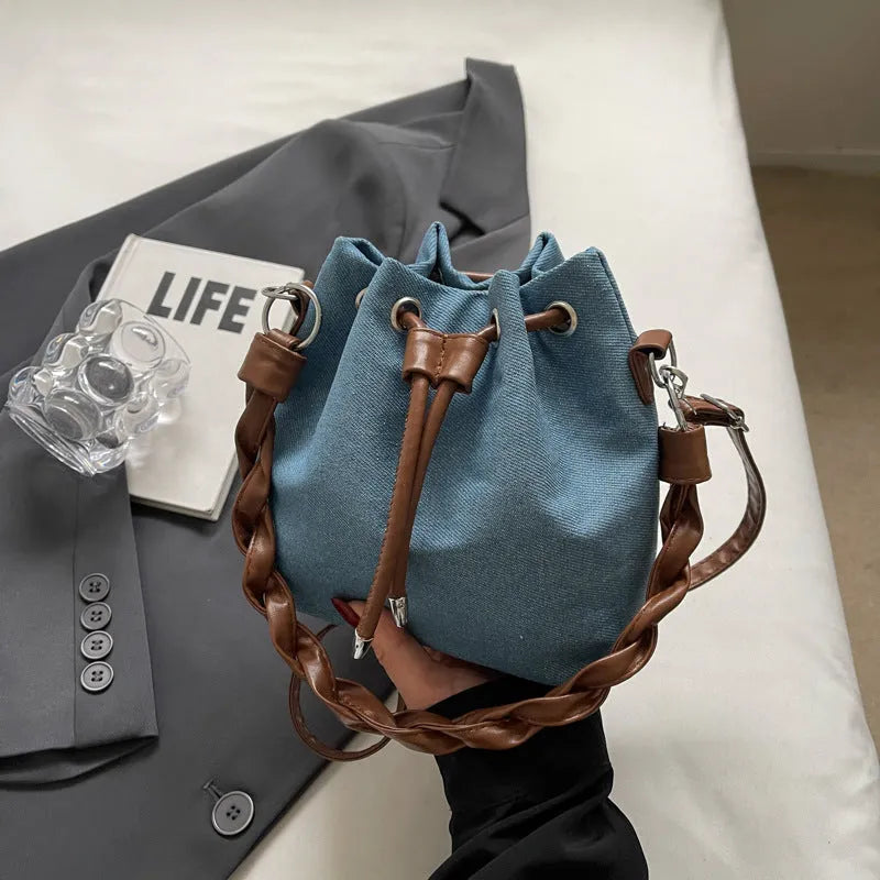 Blue synthetic leather cross body bucket bag with adjustable strap and sandwich pocket