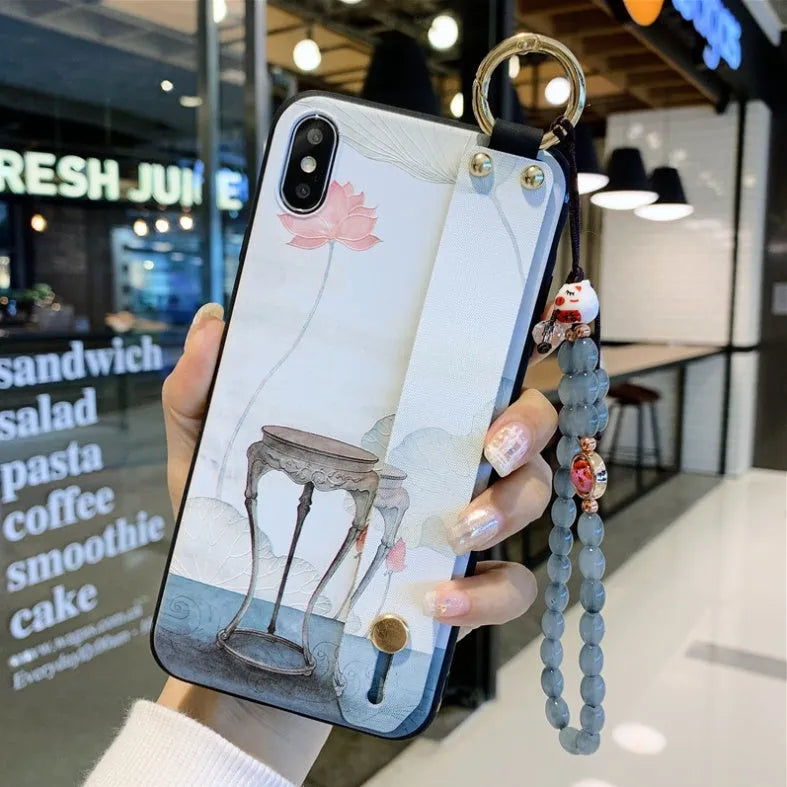 Rose floral patterned phone case with a wrist strap attachment point for iPhone.