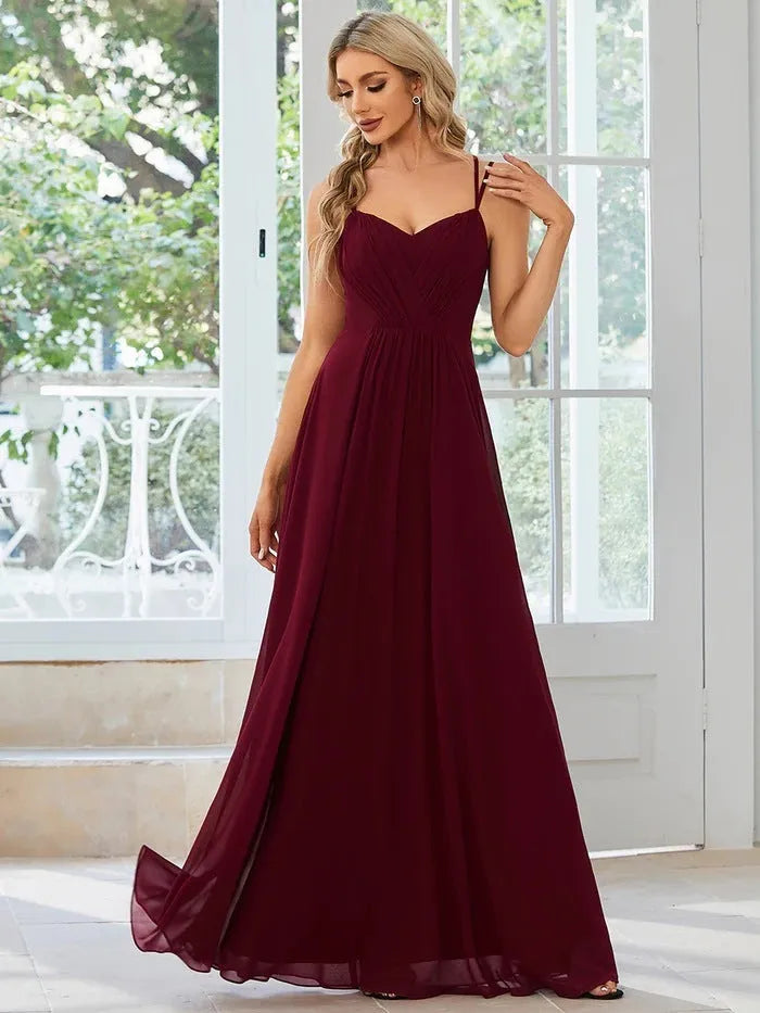 Women's long sleeveless A-line pleated dress in light green for banquet or casual wear.