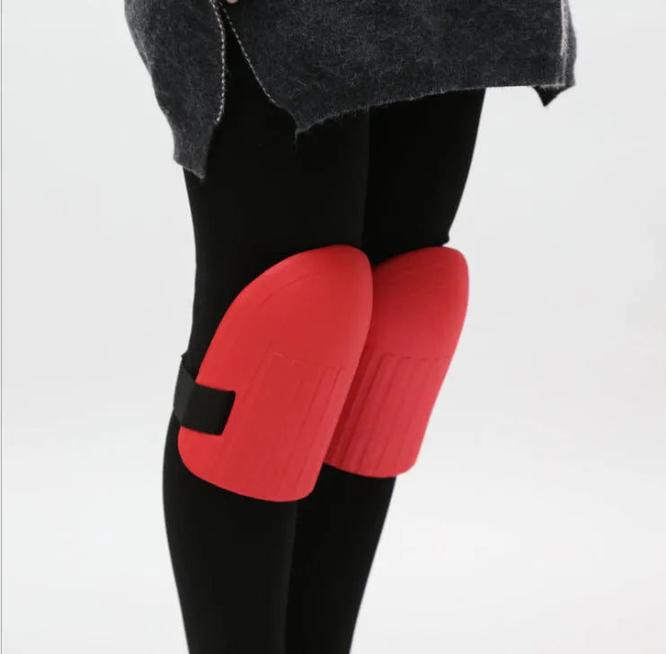 A pair of rectangular EVA foam knee pads in army green colour, shown on a garden soil background.