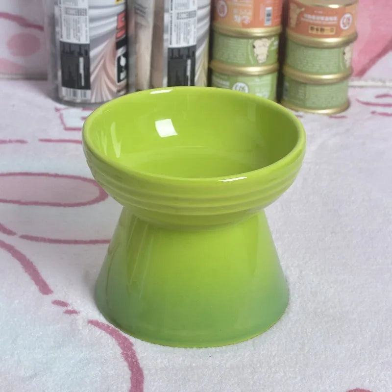 Black ceramic pet bowl with a chin-high foot and raised neck protector on a white background.