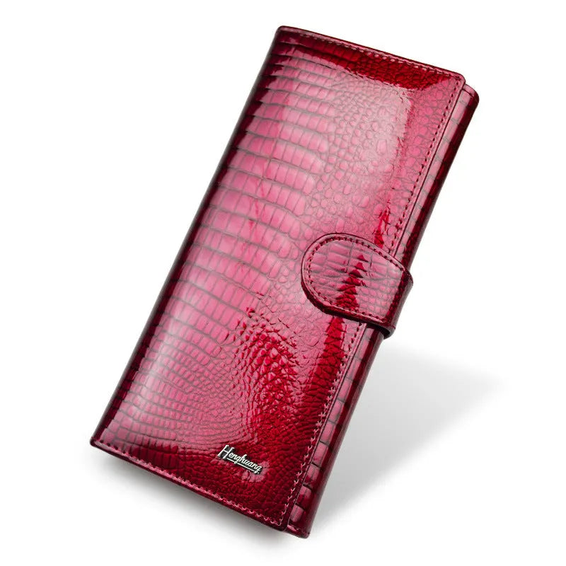 Women's red leather coin purse with a textured crocodile pattern, shown open to reveal pigskin lining.