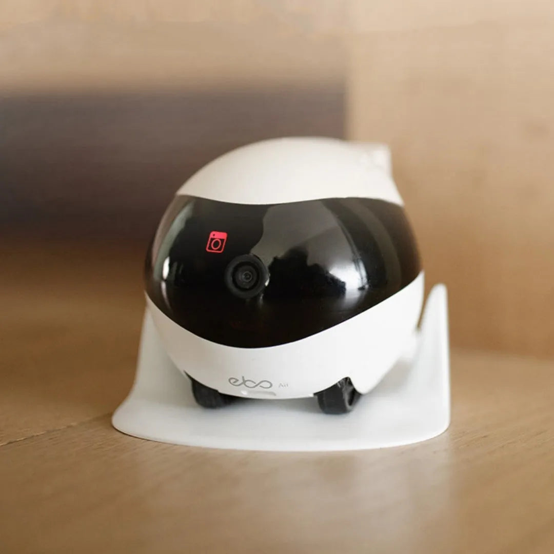 White smart home mobile surveillance robot camera on floor with docking station