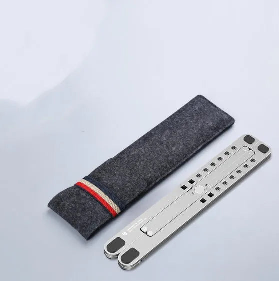 Aluminium laptop stand in silver colour, folded flat next to an open laptop for size comparison.