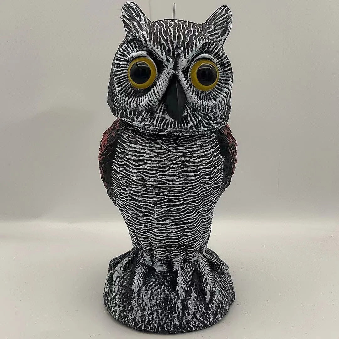 Artificial owl bait ornament with shaking head for garden bird deterrent in outdoor setting