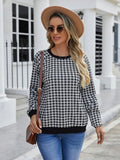 Black plaid and stripe pattern pullover sweater with long sleeves on mannequin