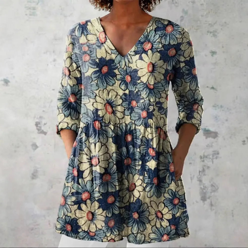 Women's slim-fit retro printed long-sleeved polyester top on a hanger, showing detail of digital print.