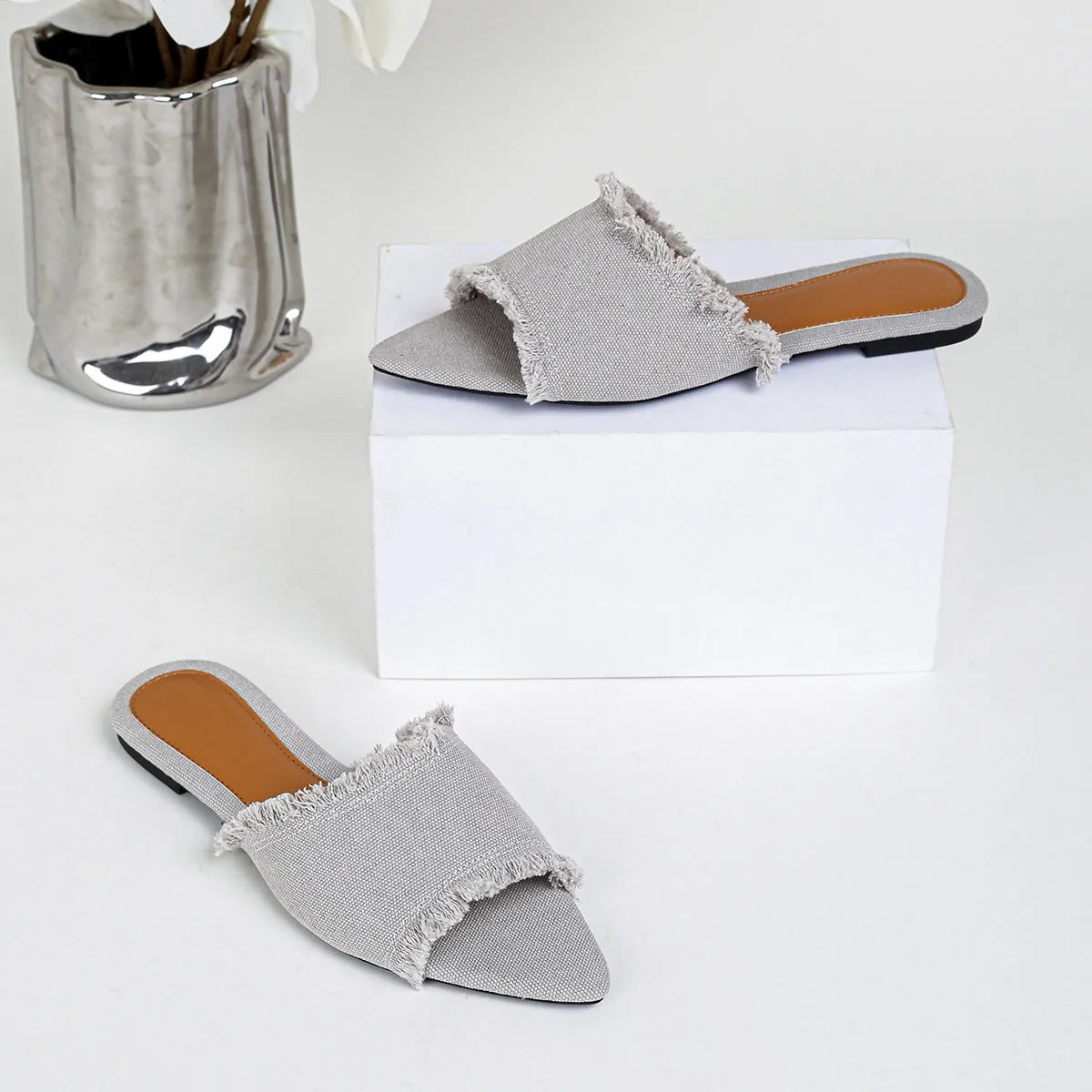 Women's denim casual flat slippers with a tassel detail in multiple colour options.