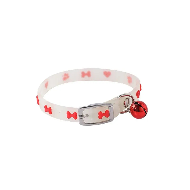 Luminous adjustable cat collar with bell in silicone and metal, showing paw print design for night visibility.