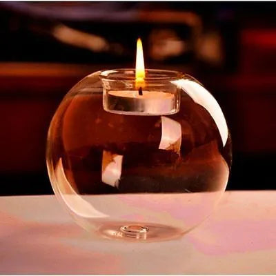 Handmade round hollow clear glass candle holder with a tea light inside, showing European style design.