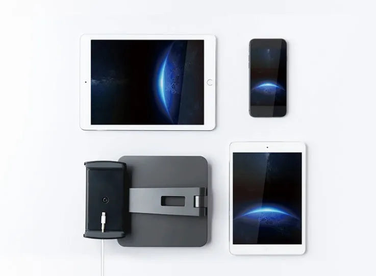Silver foldable aluminium stand holding a tablet at an angle on a desk