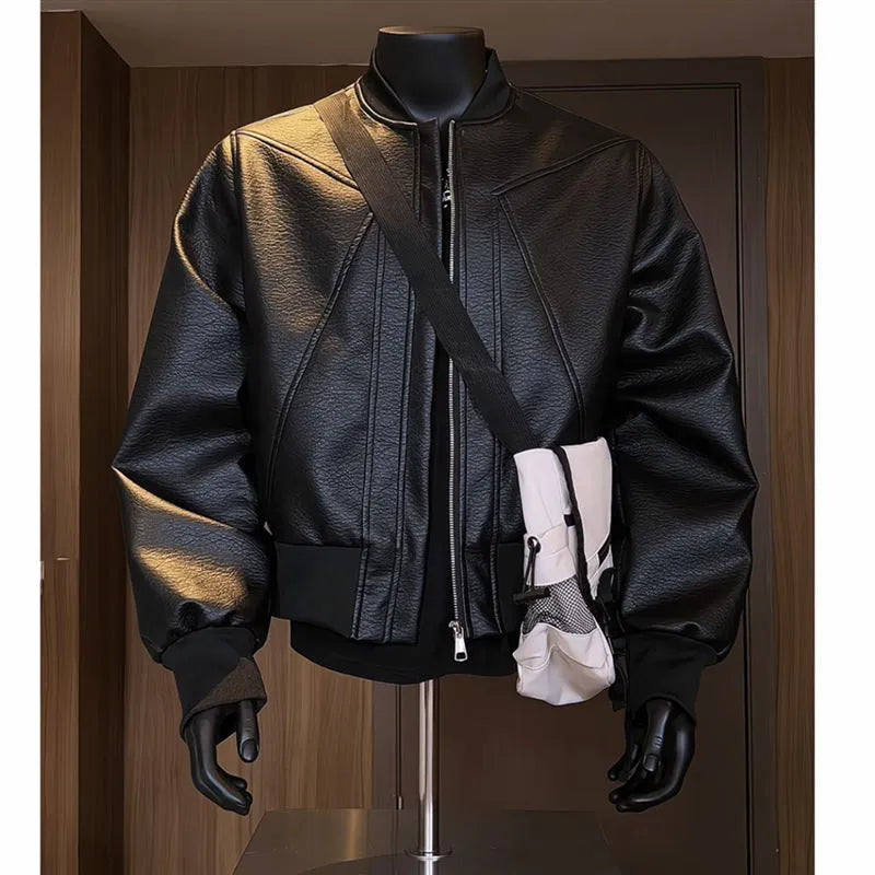 Man modelling a slim-fit black PU leather jacket with litchi grain texture and extended length.