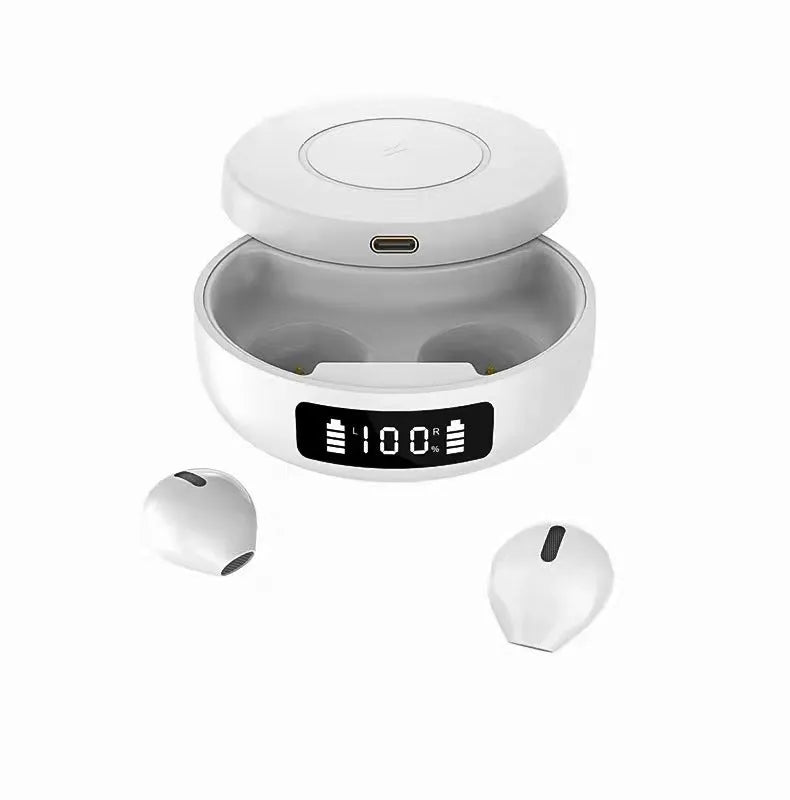 Mini black and white semi-in-ear wireless headphones with their charging case on a table.