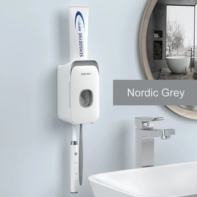 Blue automatic toothpaste dispenser with infrared sensor mounted on a bathroom wall.