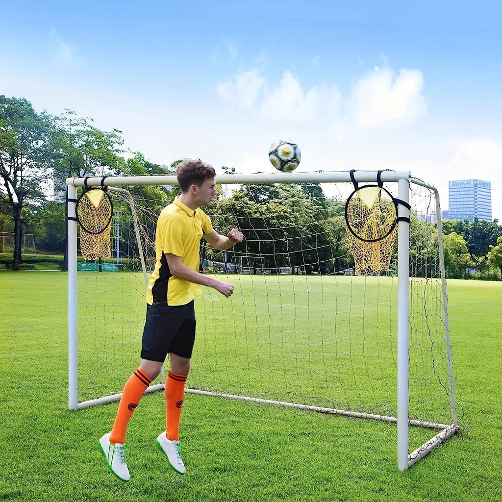 Portable black and yellow soccer training goal net set up on a grass field.