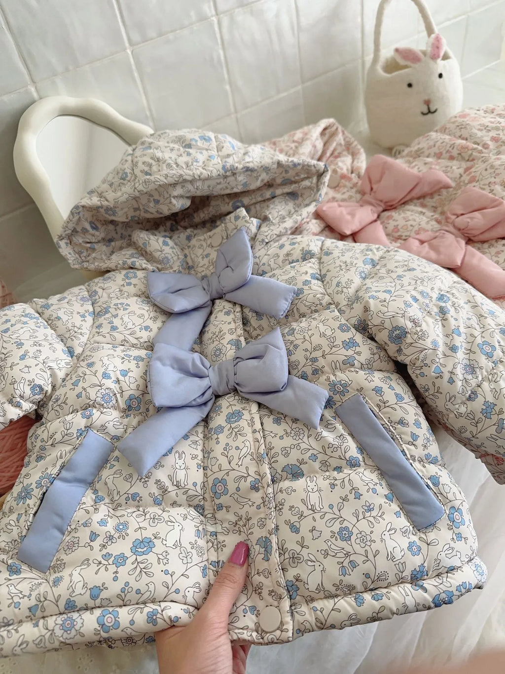 Baby girls winter floral print hooded jacket in blue and white porcelain blue with bow detail, zip-up front