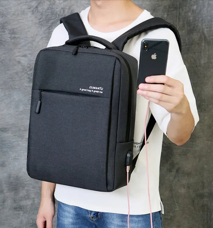 Black waterproof rechargeable backpack for a laptop, showing shoulder straps and a USB charging port.