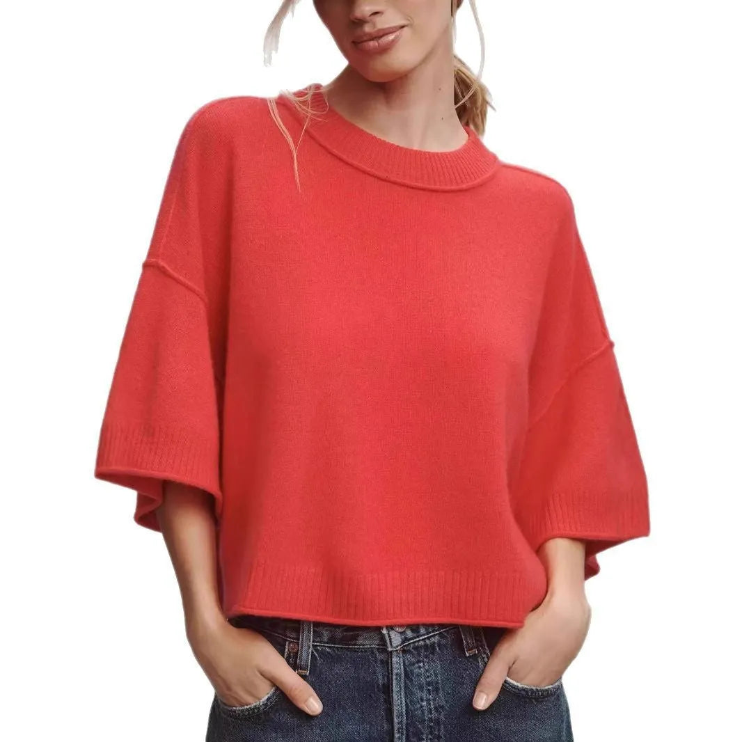 Red women's crop top t-shirt with regular sleeves on a hanger.