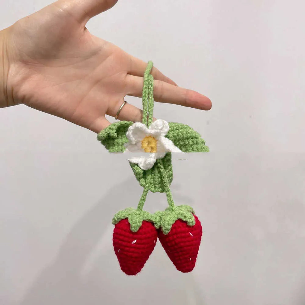 Handmade strawberry-shaped car pendant woven from cotton and hemp with natural colours