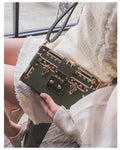 Women's black PU leather shoulder bag with flap closure and decorative rivets