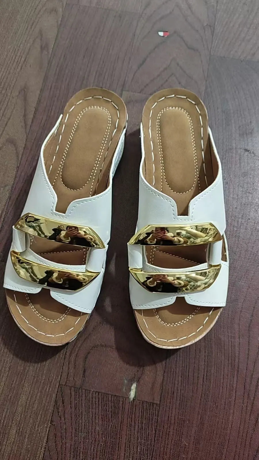 Roman style platform flip-flop sandals in white, black, khaki, and sea blue on a solid background