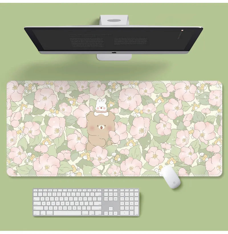 Large floral cartoon pattern mouse pad on a desk, showing non-slip rubber base and colourful design.