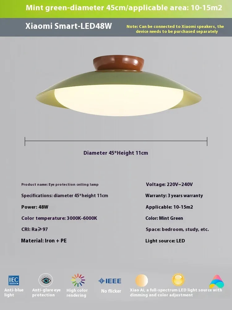 Modern cream-style flying saucer shaped ceiling lamp in a bedroom setting.
