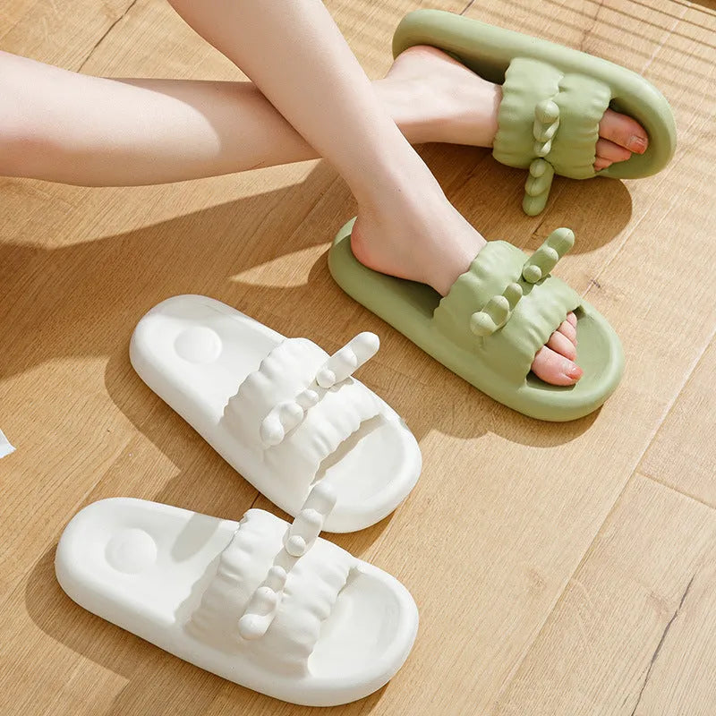 Light grey EVA flip flop slippers with a deer horn design and hollow out pattern on the upper.