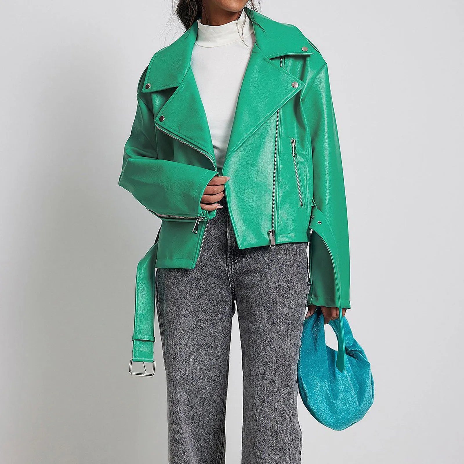 Black punk style short leather jacket with a Peter Pan collar and drawstring waist on a hanger.