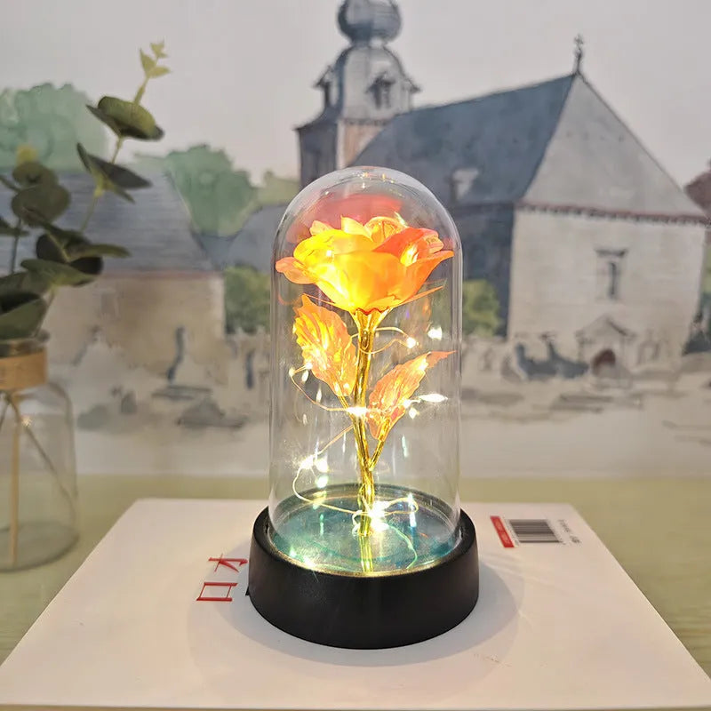 Small plastic night lamp with glass cover and flower decoration on black base