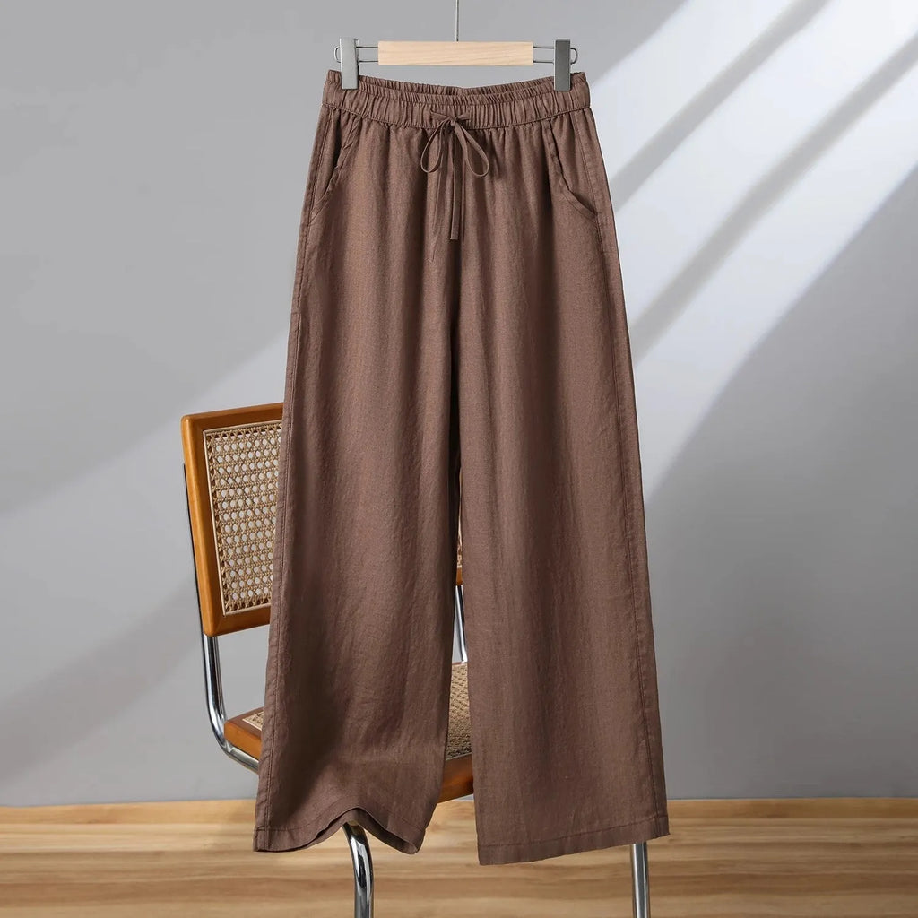Women's apricot straight-leg casual trousers with elastic drawstring waist laid flat.