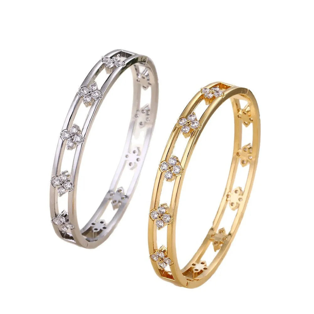 Women's hollow bracelet with four-leaf clover charm and zircon stones in gold or silver tone