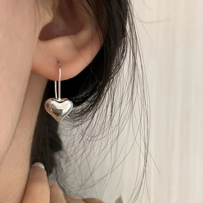Silver Korean style heart earrings with three-dimensional glossy design and heart-shaped hooks