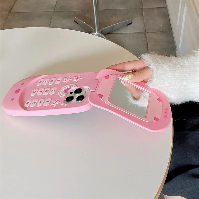 Light pink silicone flip phone case with mirror for iPhone, featuring a cute cartoon design.