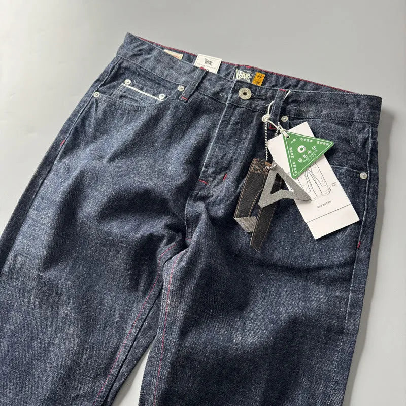 Men's straight-leg cotton denim trousers in a primary colour wash, showing mid-waist fit.