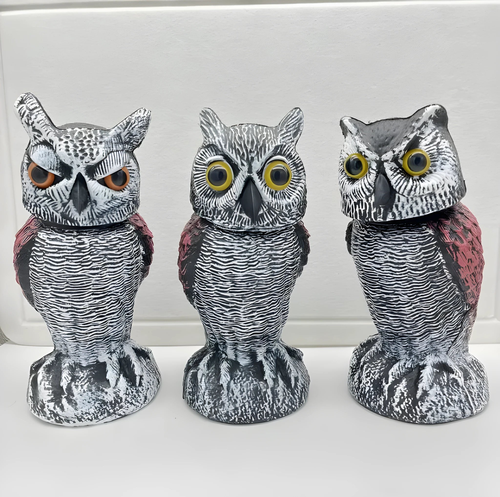 Artificial owl bait ornament with shaking head for garden bird deterrent in outdoor setting