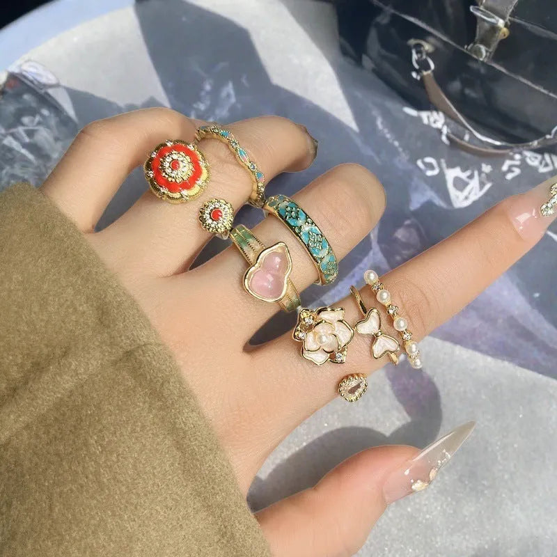 Copper adjustable ring with gourd, flower, and bow design featuring inlaid zircon stones in vintage finish.