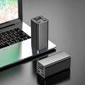 Black metal 65W laptop power bank with 20000mAh capacity showing USB ports