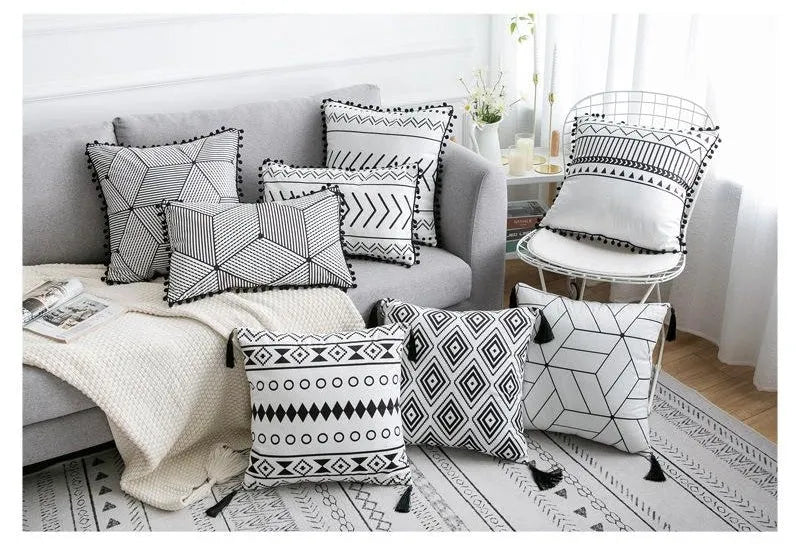 Bohemian patterned pillow cover in light gray on a living room sofa with decorative throw