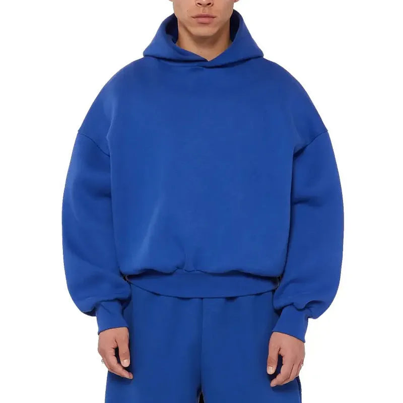 Men's grey fleece-lined cotton pullover hoodie with long sleeves on a hanger.