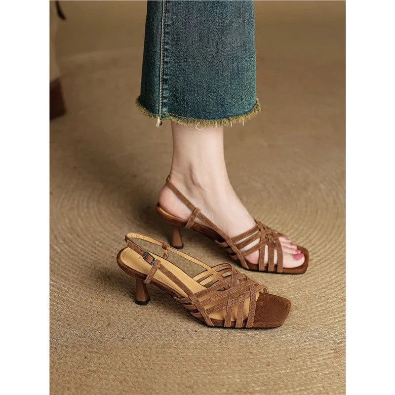 Light brown retro women's sandals with thin cross straps, ankle buckle, square toe, and a mid heel.