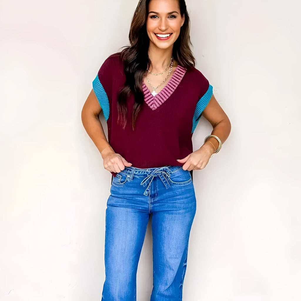 Burgundy women's loose sweater with contrast trim, V neck, and cuffed short sleeves.