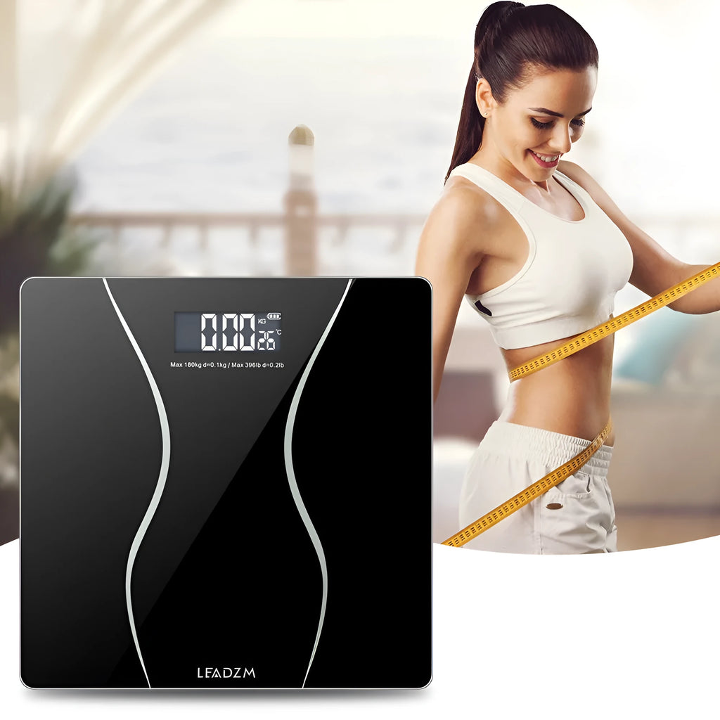 Black electronic bathroom scale with digital display showing weight measurement up to 180kg