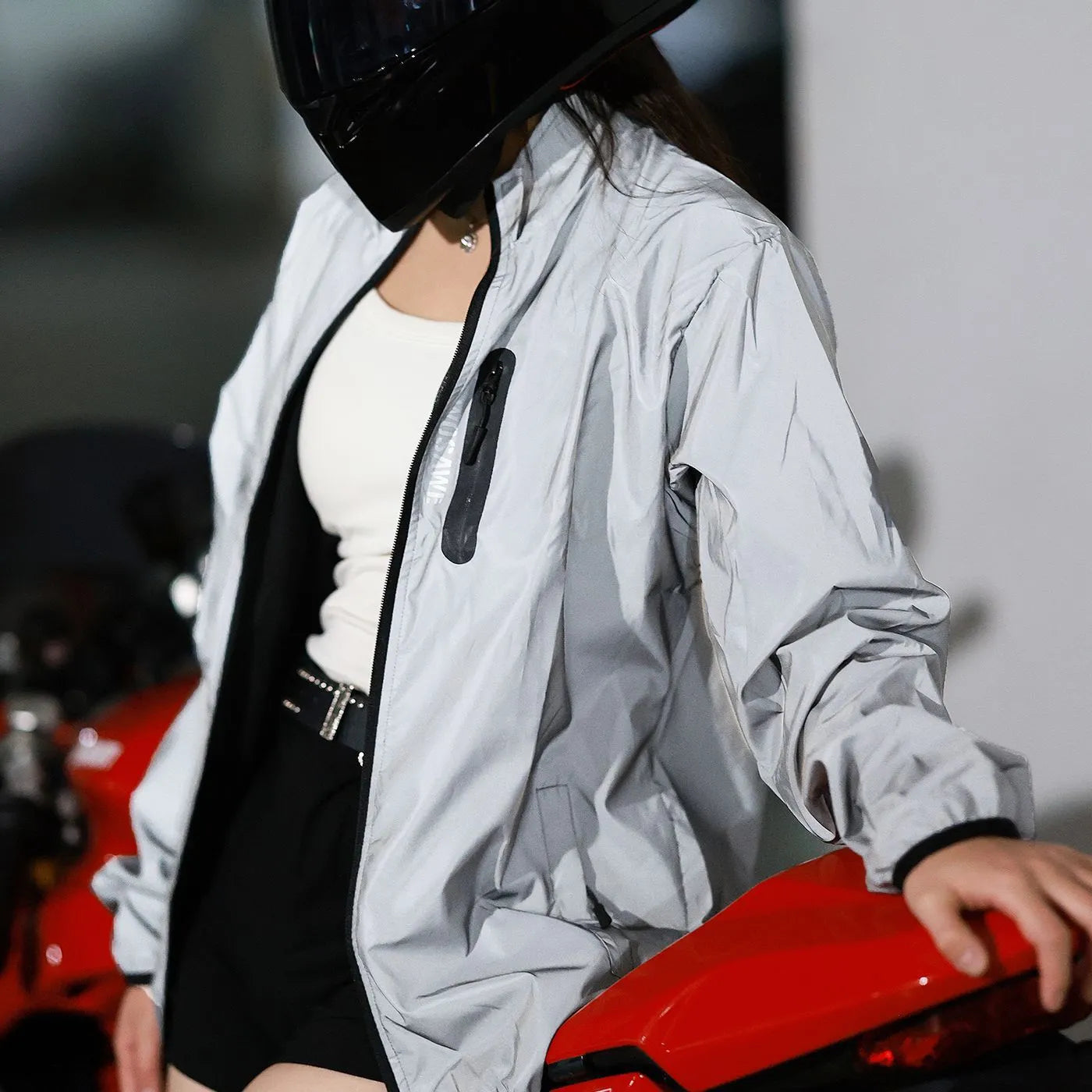 Silver waterproof polyester long sleeved jacket with windproof function, shown on hanger