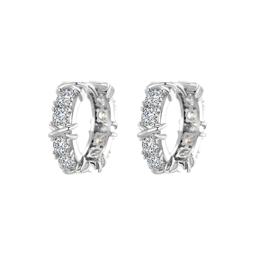 A pair of geometric clover cross earrings with a hexagonal shape in a silver or gold electroplated finish.