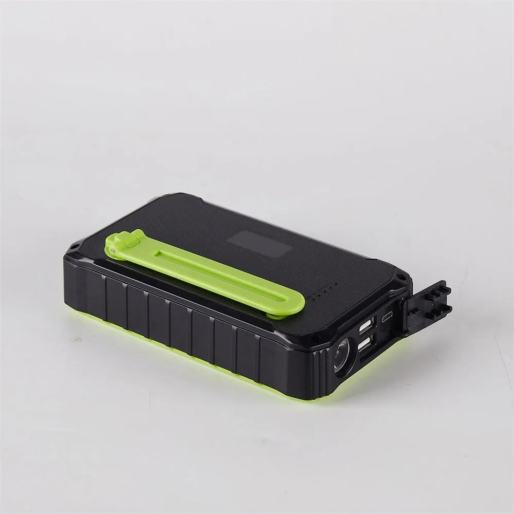Orange and green portable solar hand crank power bank with USB ports and LED light