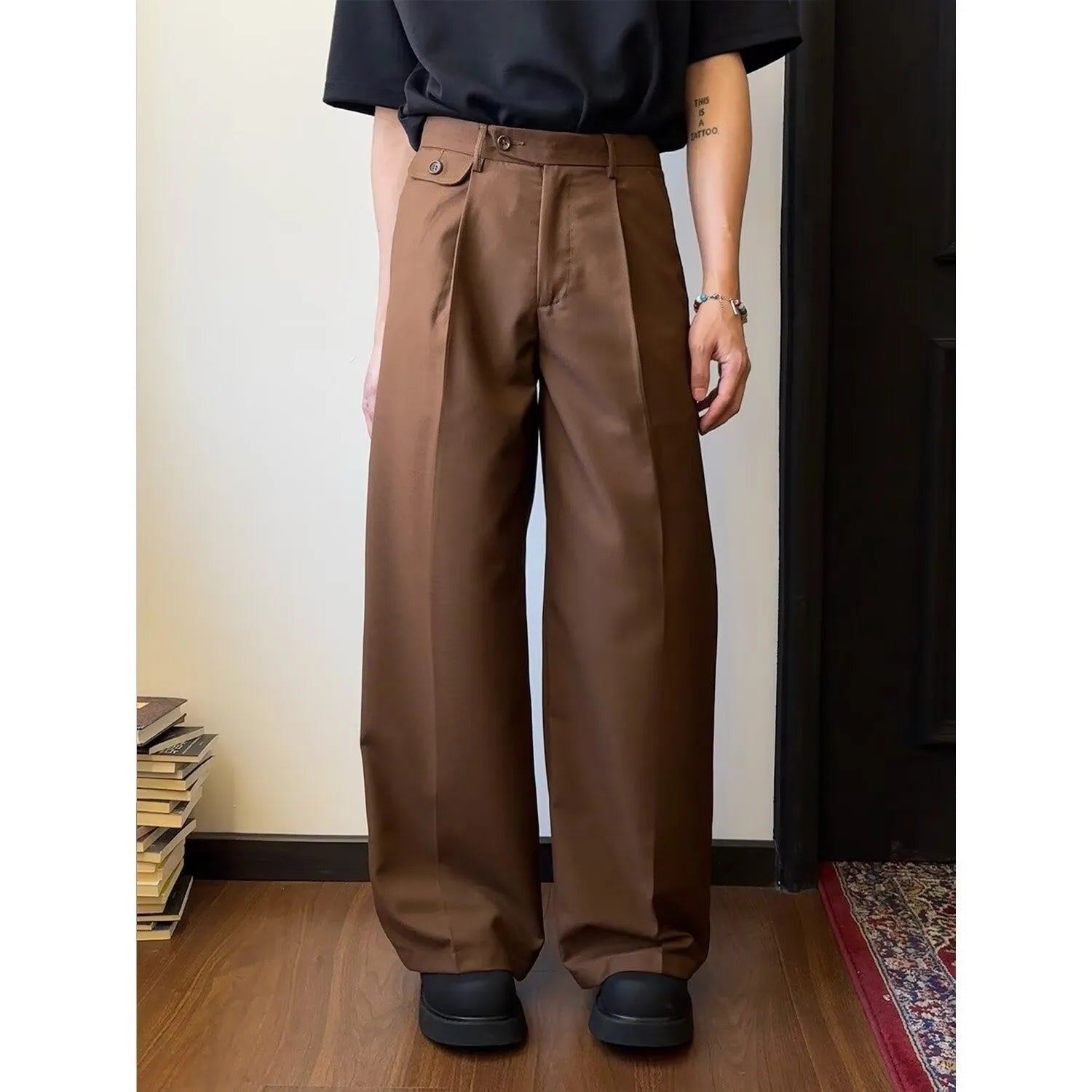 Men's straight-leg wide casual suit pants in brown solid colour, showing loose drape fit.