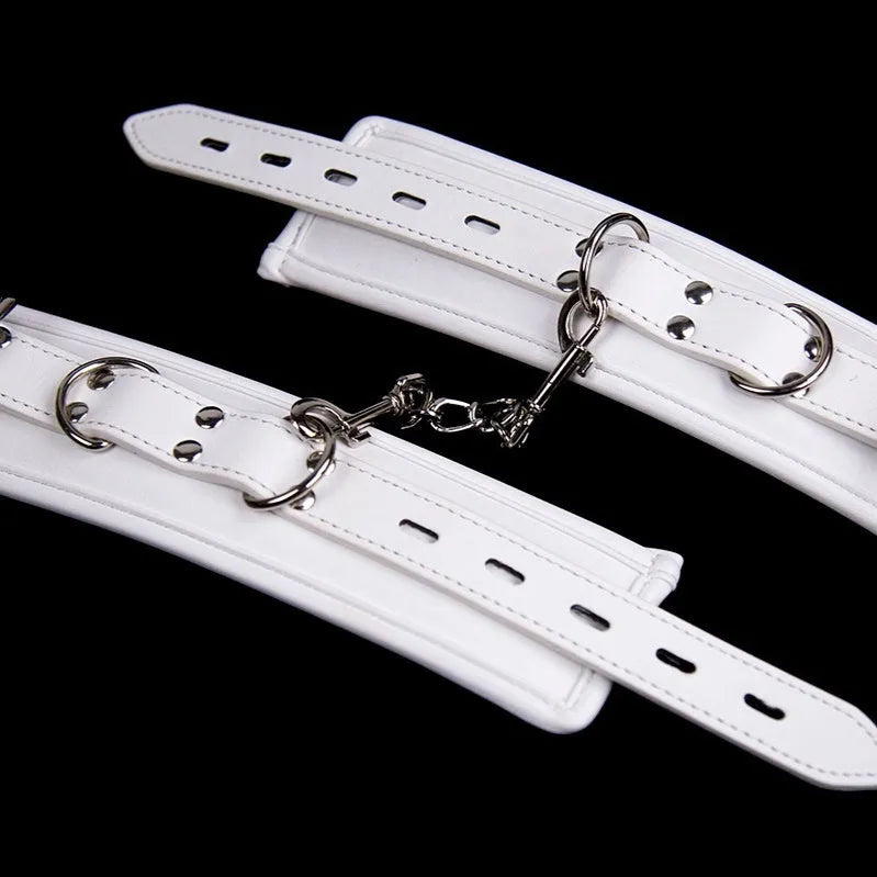 White PU sponge bondage set showing soft handcuffs, an ankle cuff, and a neck restraint.