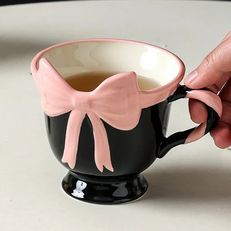 Ceramic mug with bow and heart design in white powder or black pink colours